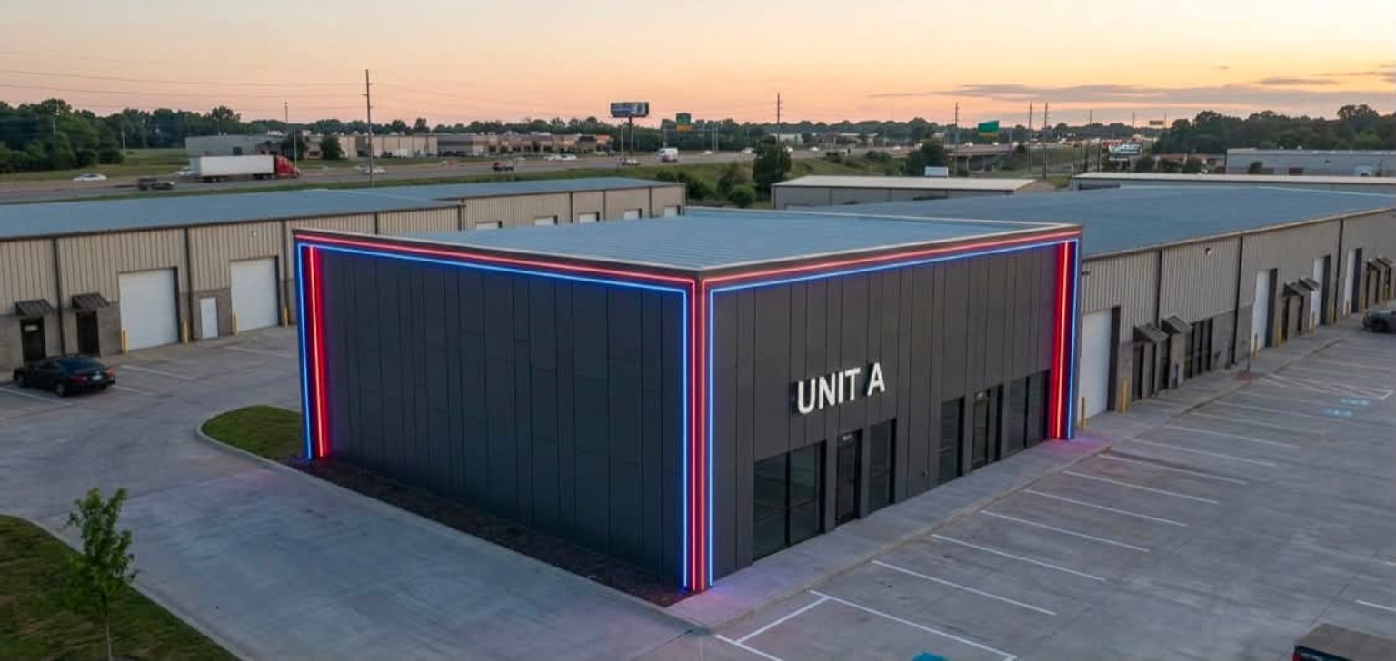 Modern dark metal industrial unit with illuminated architectural accents